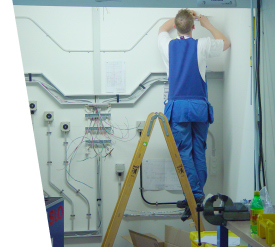 MC Electrical electrician on a stepladder installing wiring and conduit